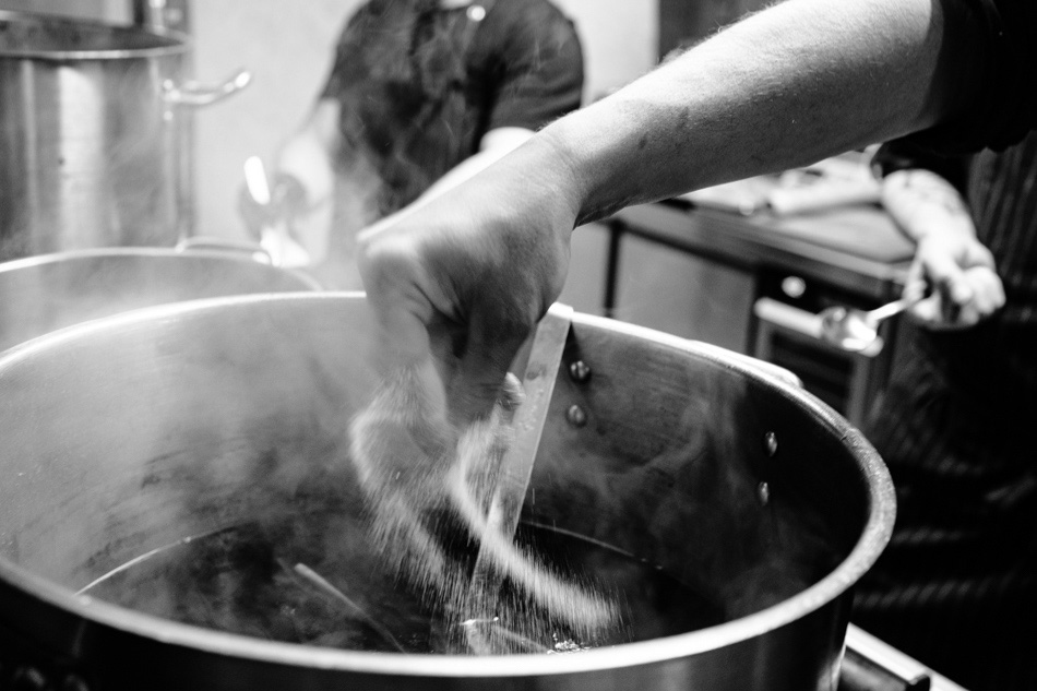 Gotowanie i przyprawianie garnka bulionu w kuchni w bielskiej restauracji